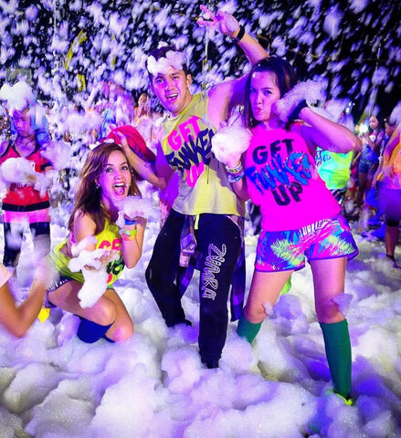 Friends throwing foam in the air